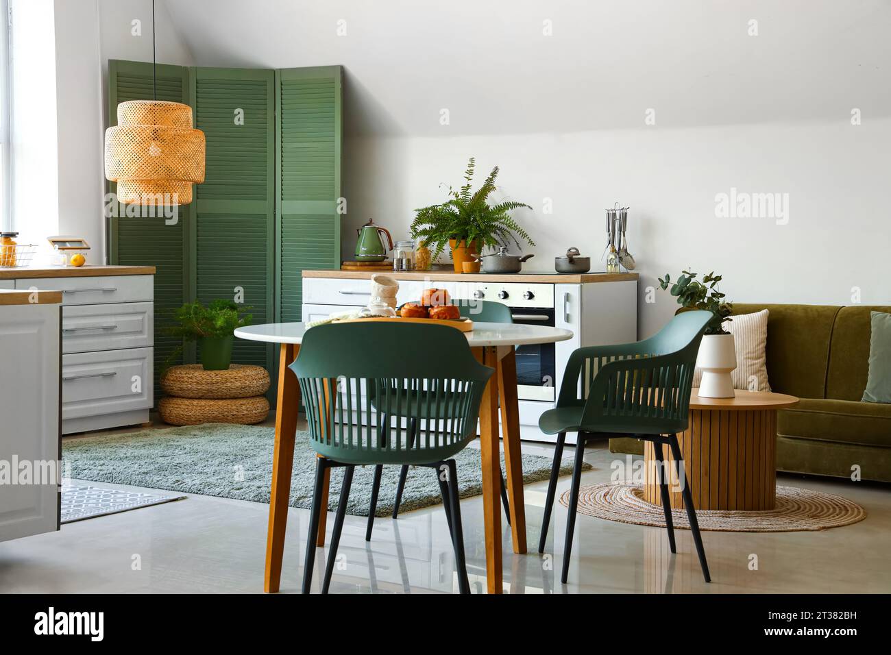 Interior of modern kitchen with white counters and dining table Stock ...
