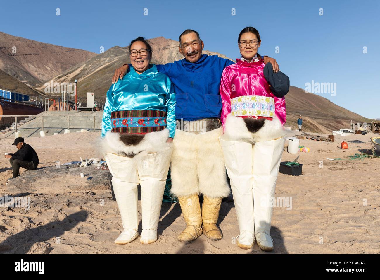 Three Greenlandic adults in traditional dress - Siorapaluk, Greenland Stock Photo