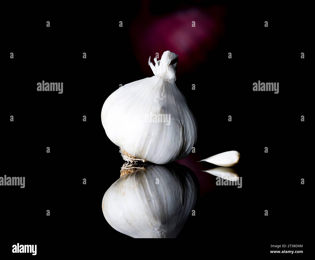 Garlic on black background with one clove Stock Photo - Alamy