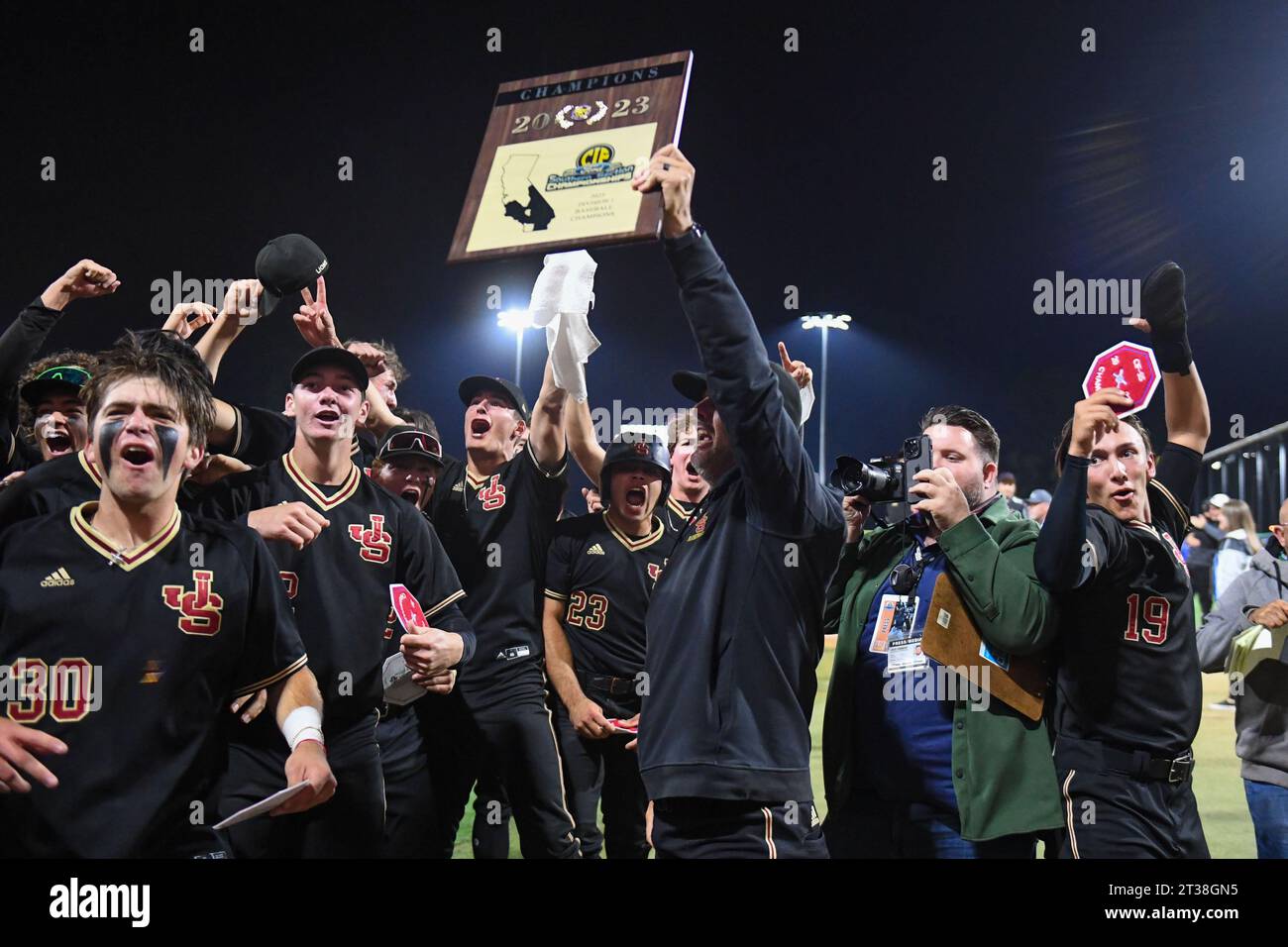 JSerra Lions assistant coach Bob Ickes presents the championship trophy after the CIF Southern