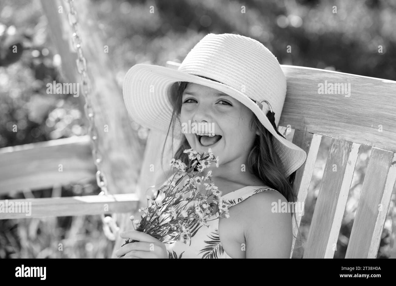 Outdoor small child girl portrait on the meadow. Little cute kid with