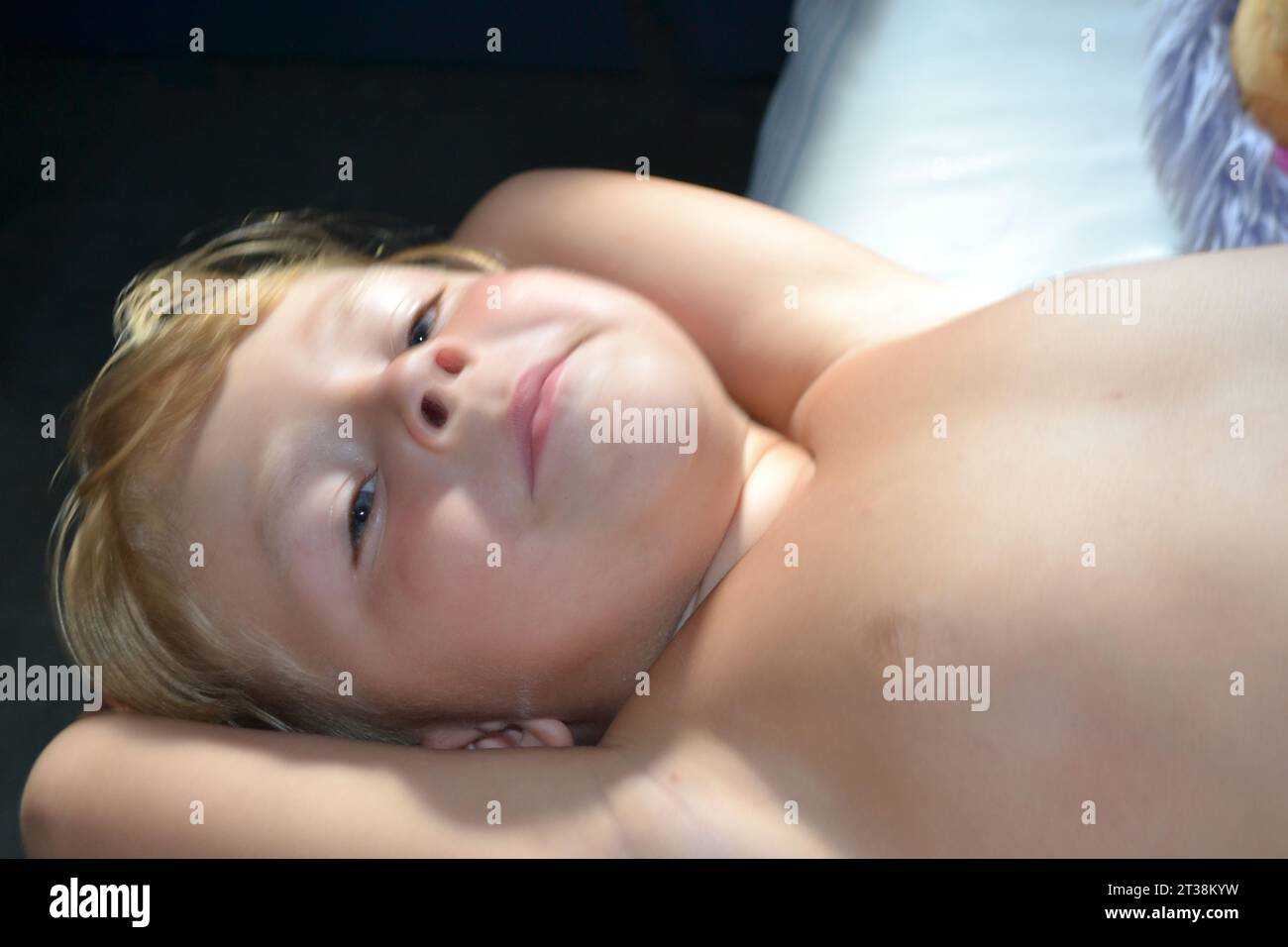 Just awaked boy. Portrait of a cute handsome child awakened. Happy smiling boy toddler infant laid. Little boy travels by train. High quality photo Stock Photo