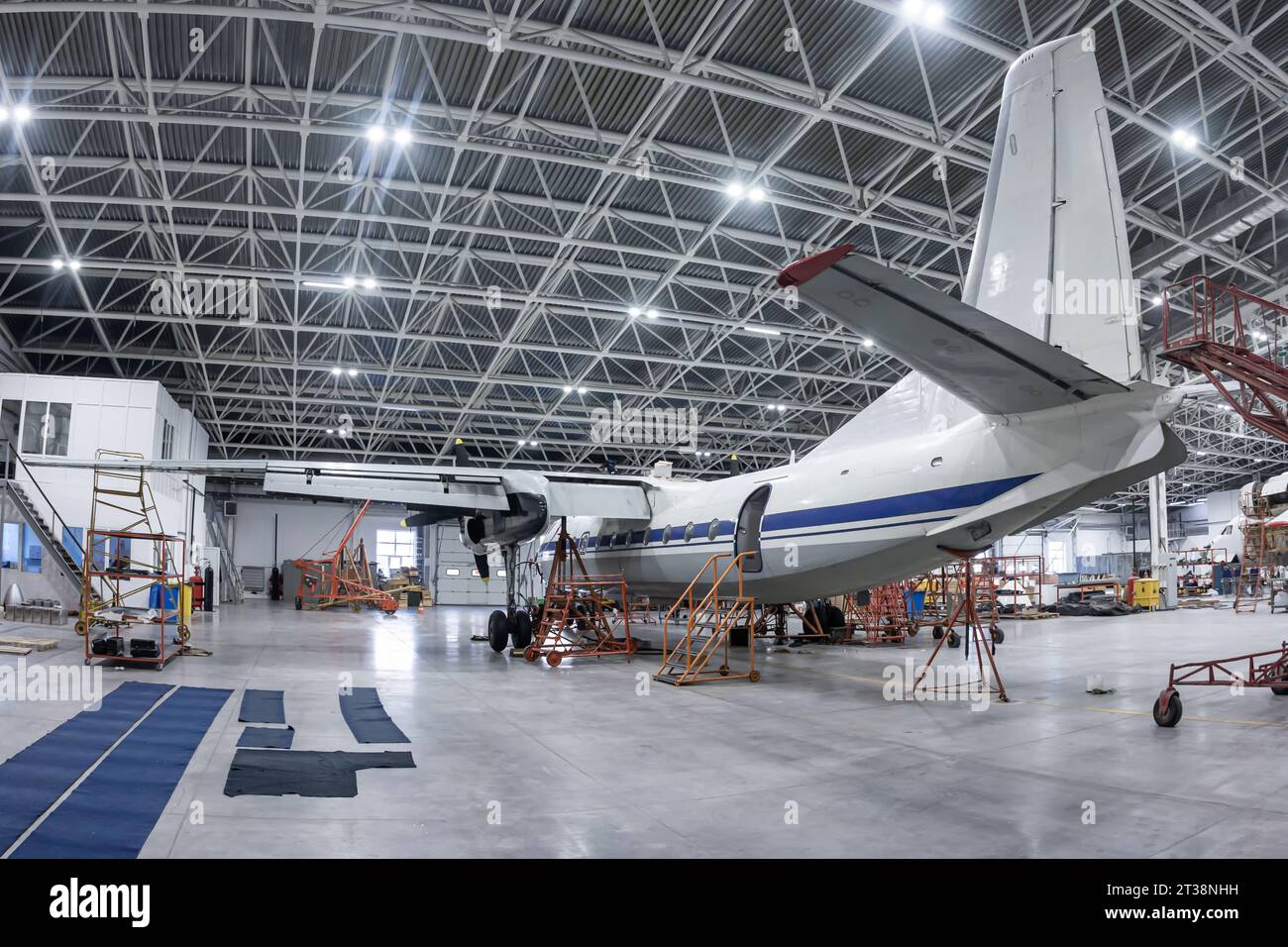 Transport turboprop airplane in the hangar. Aircraft under maintenance ...