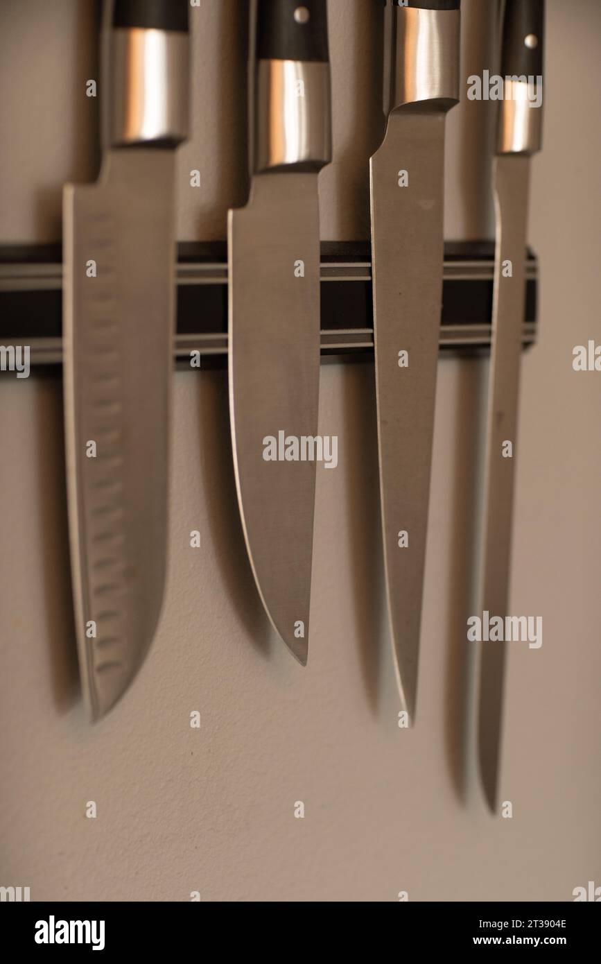 https://c8.alamy.com/comp/2T3904E/kitchen-chefs-knifes-on-magnetic-knife-block-holder-hanging-on-white-wall-2T3904E.jpg