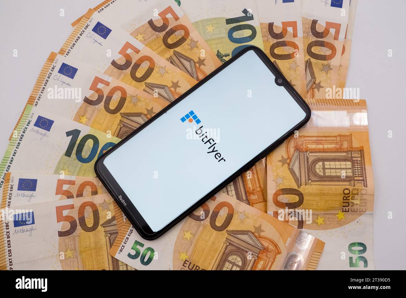 Athens, Greece. 24th Oct, 2023. In this photo illustration a bitFlyer logo seen displayed on a smartphone screen on 50 and 100 Euro bills in Athens, Greece on October 24, 2023. (Photo illustration by Nikolas Kokovlis/NurPhoto)0 Credit: NurPhoto SRL/Alamy Live News Stock Photo