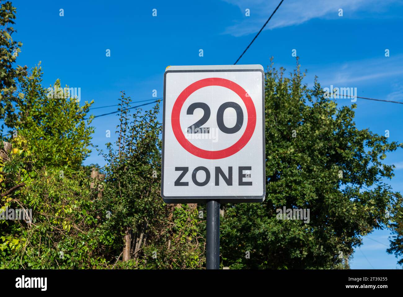 UK Traffic sign showing a 20 mph maximum speed limit with a red and white warning circle Stock Photo