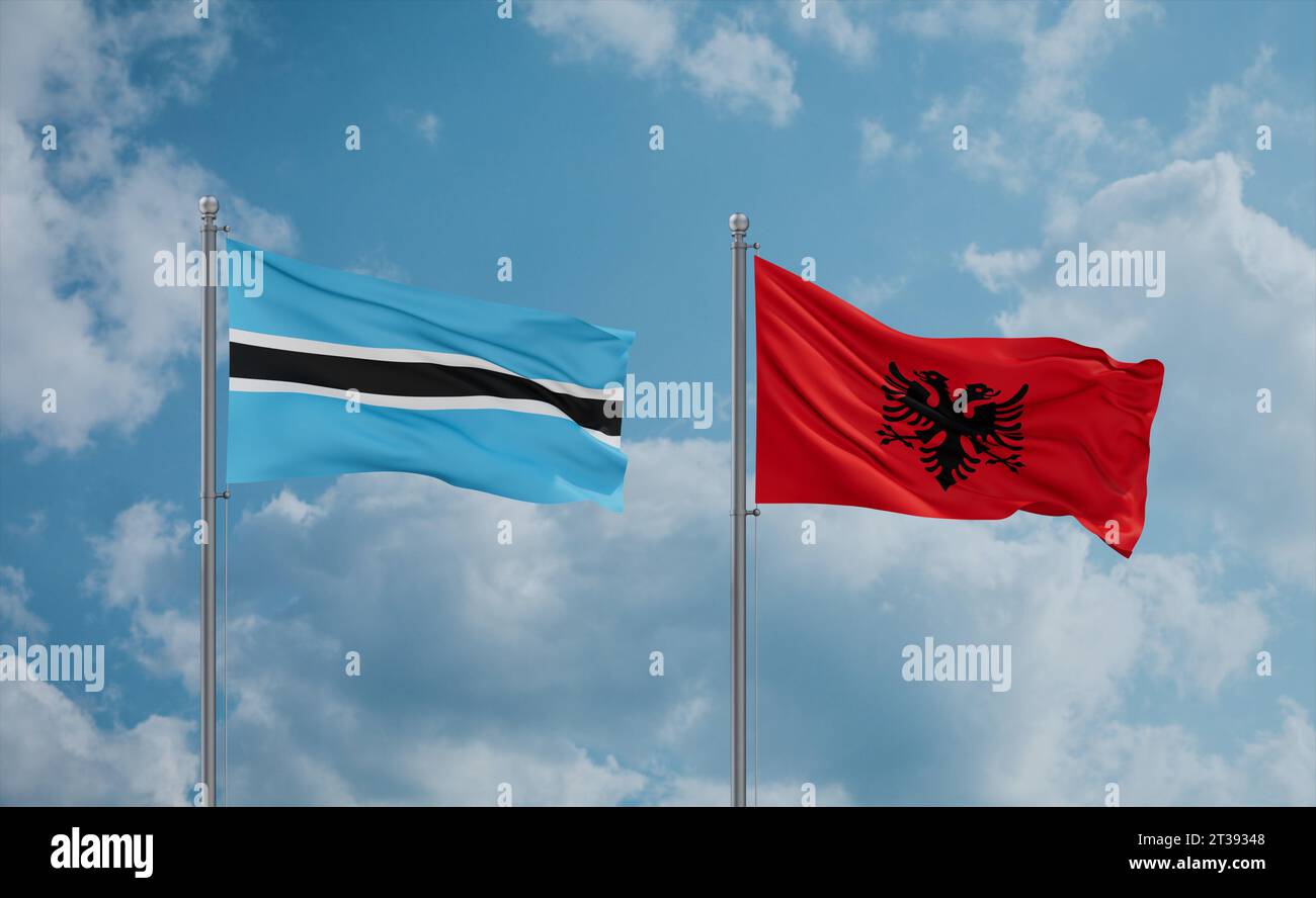 Botswana and Albania flags waving together in the wind on blue cloudy ...