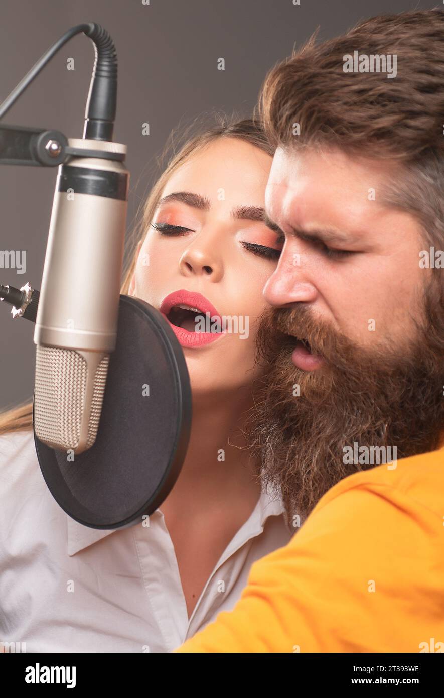 Couple in recording studio. Music performance vocal. Singer singing ...