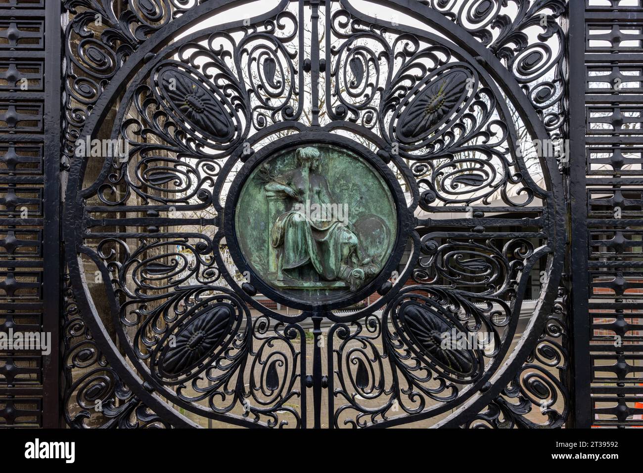 The Hague, Netherlands - April 17, 2023: Figure of Peace (Pax) on the black wrought iron gates of the Peace Palace in The Hague, which houses the Inte Stock Photo