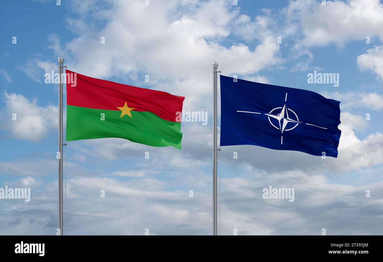 NATO and Burkina Faso flags waving together on blue cloudy sky, cooperation concept Stock Photo