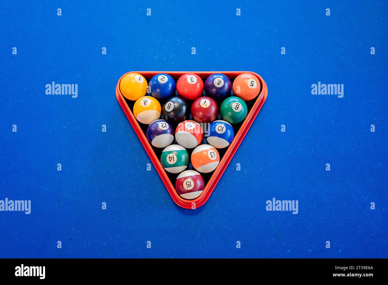 Top view of colorful pyramid of billiard balls in billiard triangle on