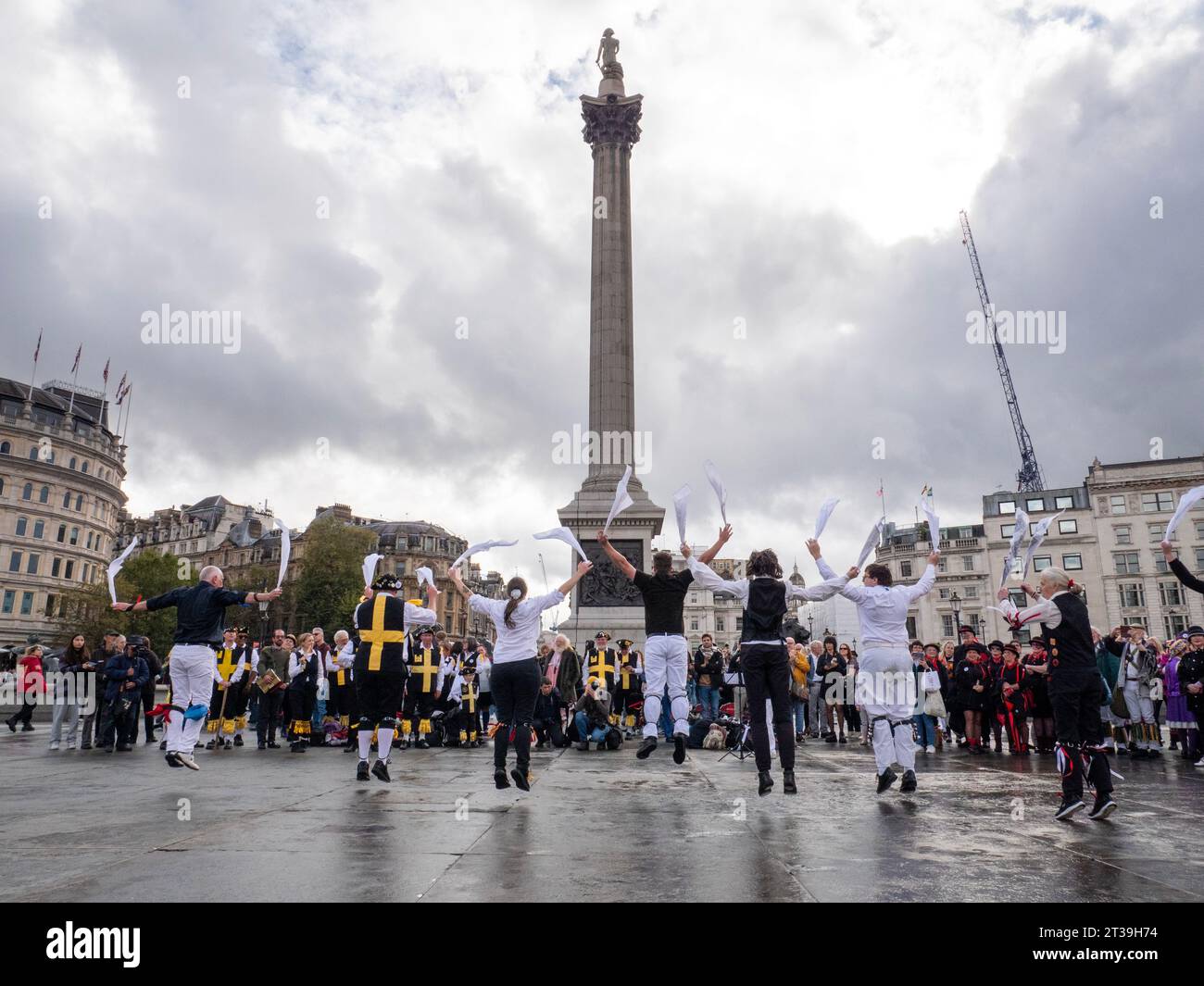 Morris Dancers in Trafalgar Square at the Joint Morris Organisations  Regional Day of Dance 2023 organised by The Morris Federation, The Morris Ring, and Open Morris, with Nelsons Column in background Stock Photo