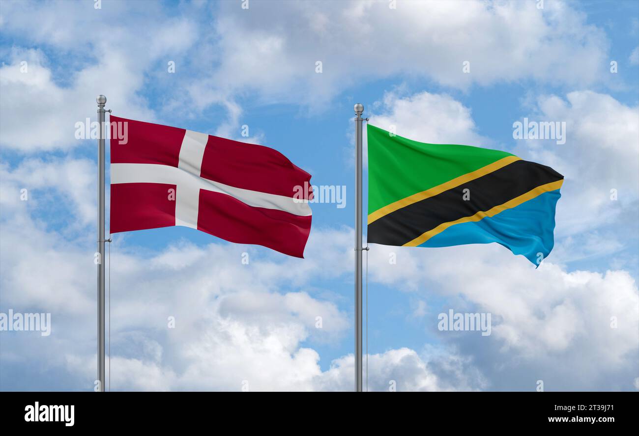 Tanzania and Denmark flags waving together in the wind on blue cloudy ...