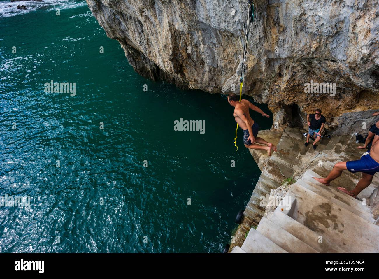 jumping into the sea, cliffs of Del Caballo lighthouse, Buciero mountain, Santoña, Cantabria, Spain Stock Photo