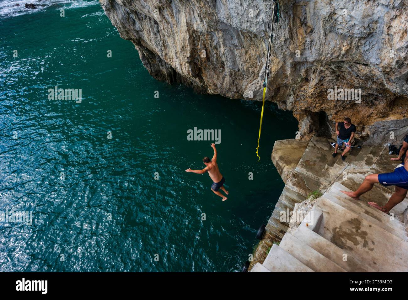 jumping into the sea, cliffs of Del Caballo lighthouse, Buciero mountain, Santoña, Cantabria, Spain Stock Photo
