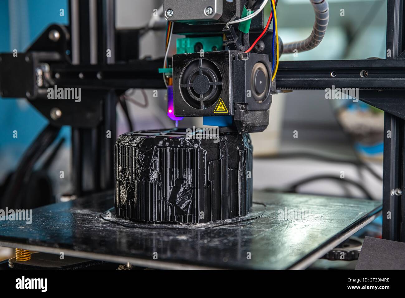 A 3D printer prints a black model. Technology at home Stock Photo