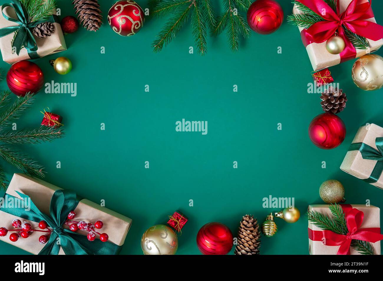 Holiday green background with gift boxes tied with silk ribbons and Christmas decorations. Christmas holiday background. Top view with copy space. Stock Photo