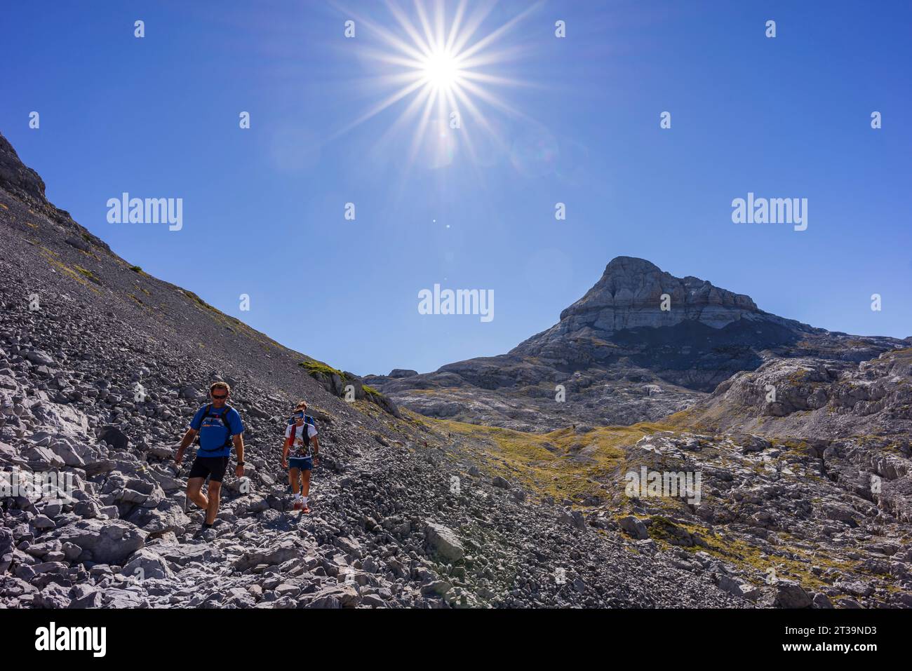 hiker walking under a hot sun, Anie peak, Larra limestone plateau, Navarrese-French Pyrenees, Navarra, Spain Stock Photo