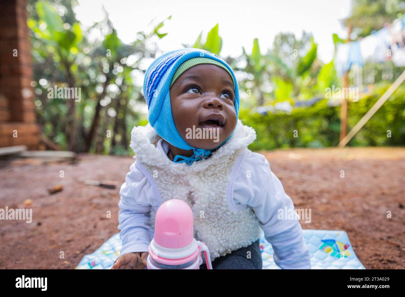 Cute and gorgeous African baby boy looking smilingly at the sky. Stock Photo