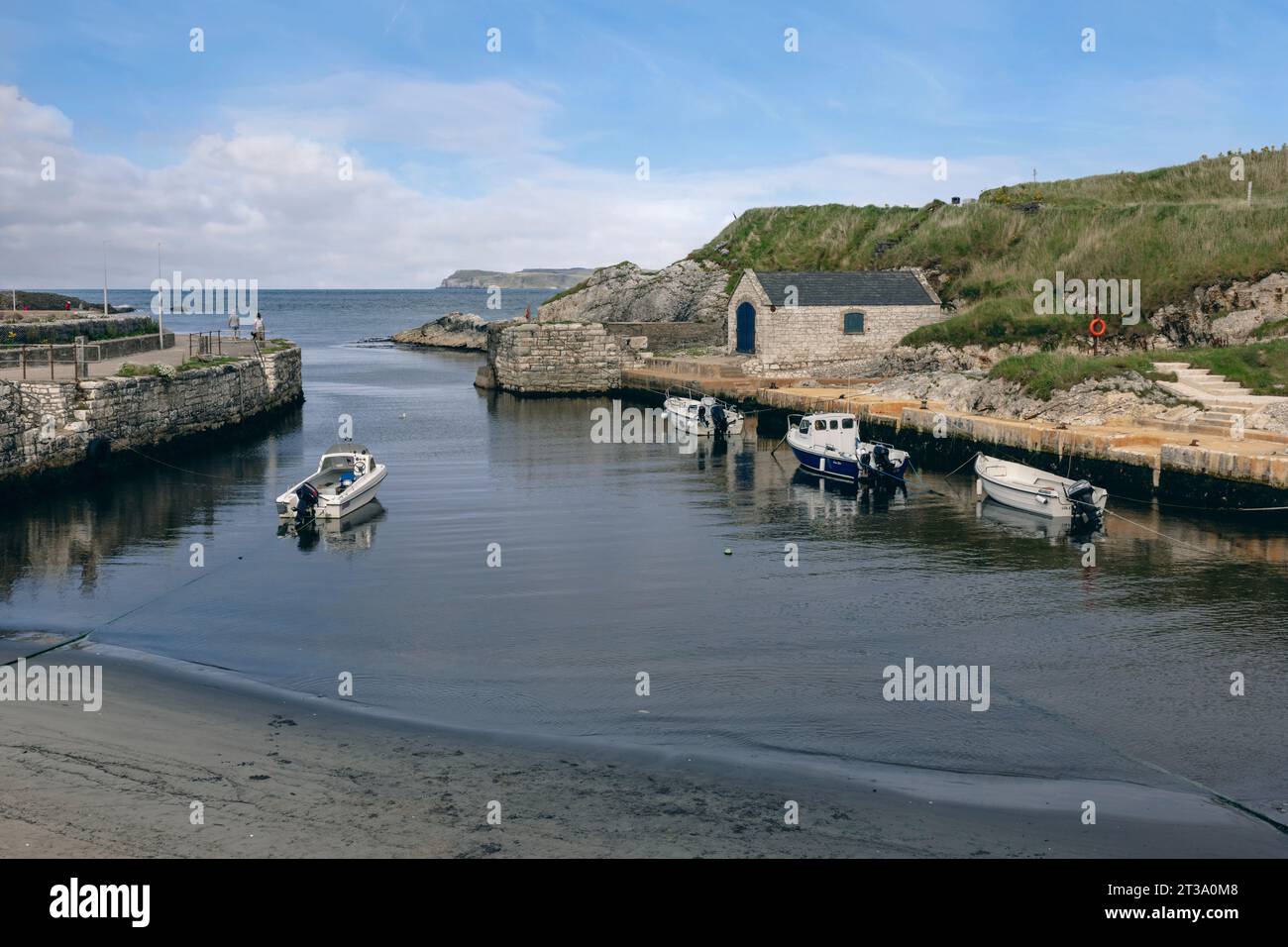 Ballintoy, Northern Ireland is a picturesque fishing village with a dramatic coastline and many sea stacks made of basalt, a type of volcanic rock. Stock Photo