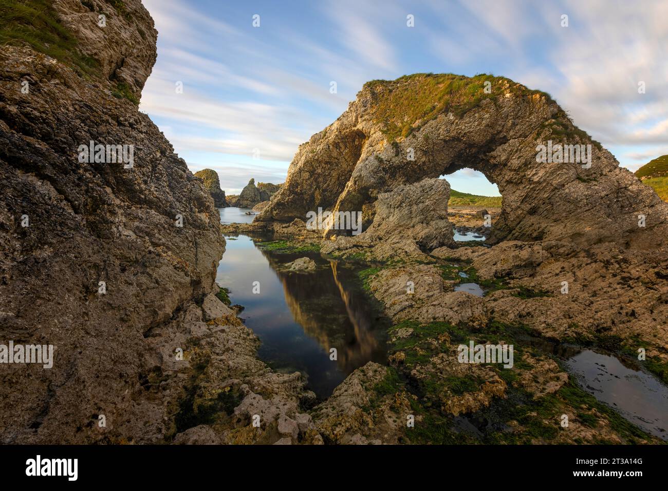 Ballintoy, Northern Ireland is a picturesque fishing village with a dramatic coastline and many sea stacks made of basalt, a type of volcanic rock. Stock Photo