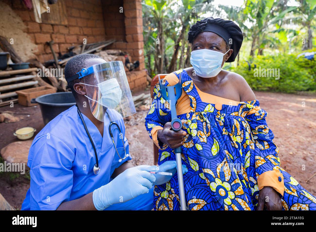 The village doctor visits a sick old woman and gives her an injection. Stock Photo