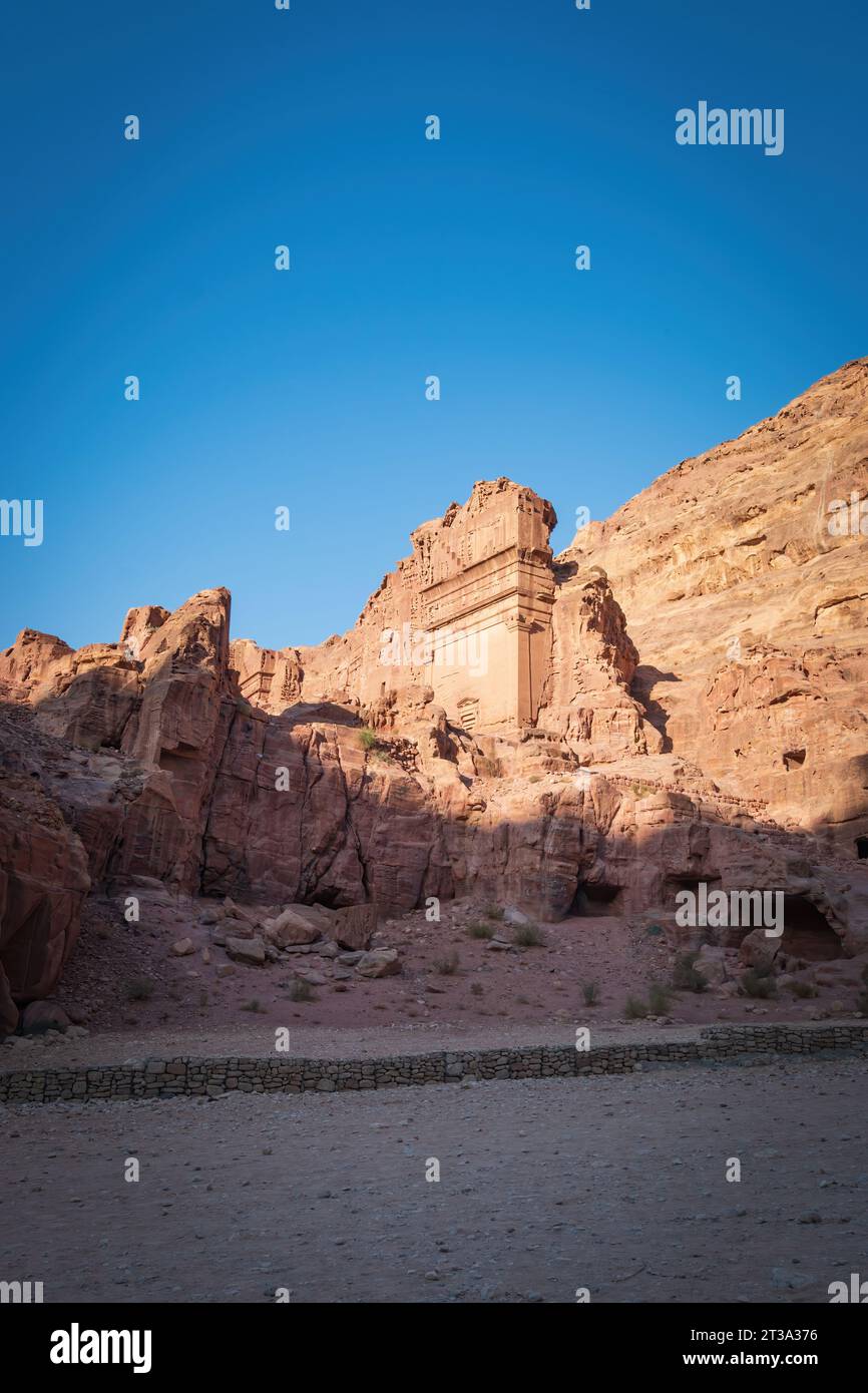 Part of the tomb of Unayshu in the historic and archaeological city of Petra, Jordan against blue sky Stock Photo