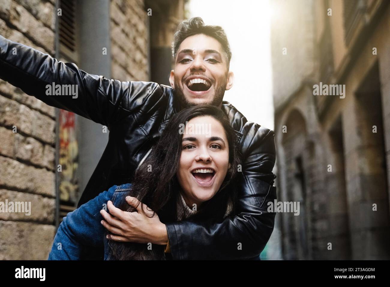 Diverse people celebrating at camera together in city street - Transgender person laughing with friend outside - Youth community concept Stock Photo