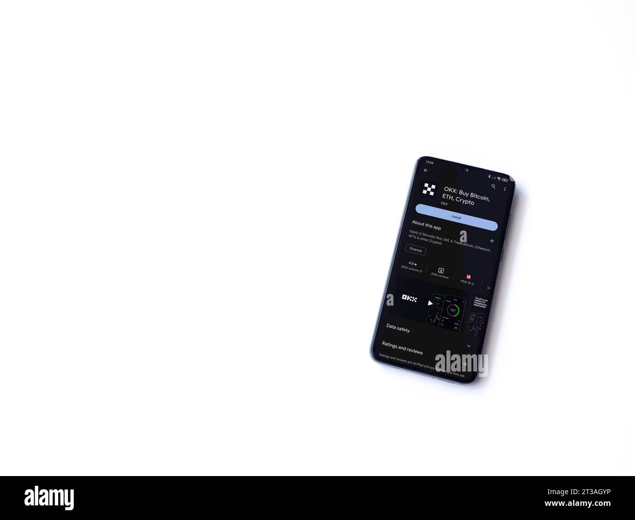 Lod, Israel - July 16,2023: OKX app play store page on smartphone on white background. Top view flat lay with copy space. Stock Photo