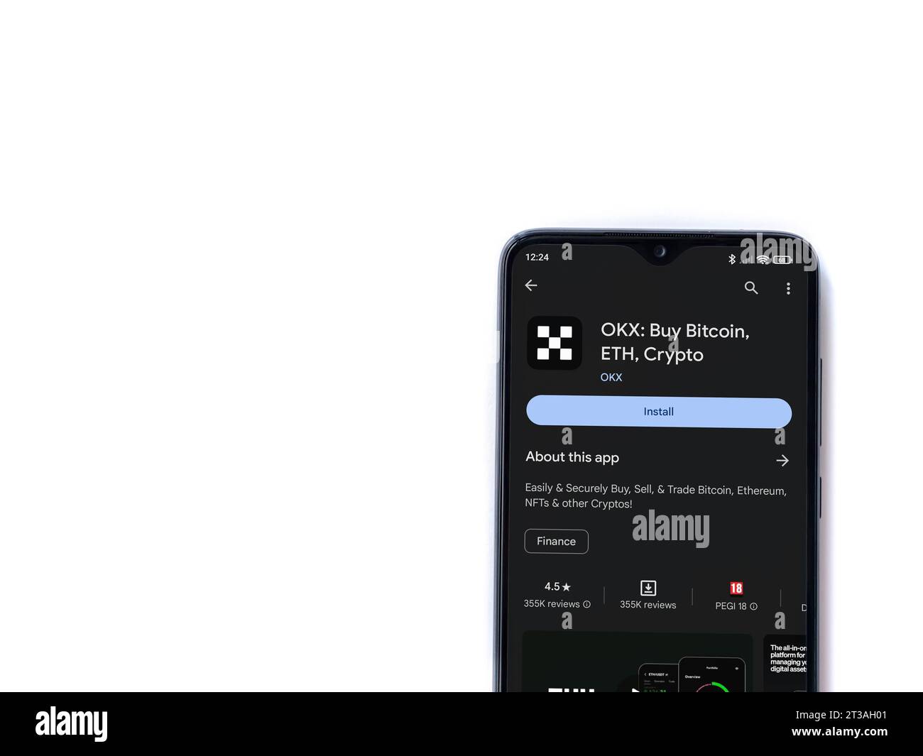 Lod, Israel - July 16,2023: OKX app play store page on smartphone on white background. Top view flat lay with copy space. Stock Photo