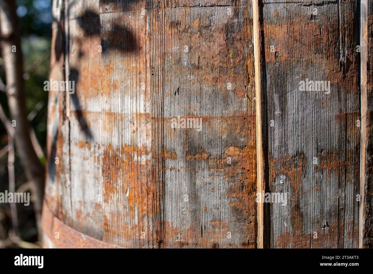 Obsolete wooden barrel with rust pattern, soft focus close up Stock Photo