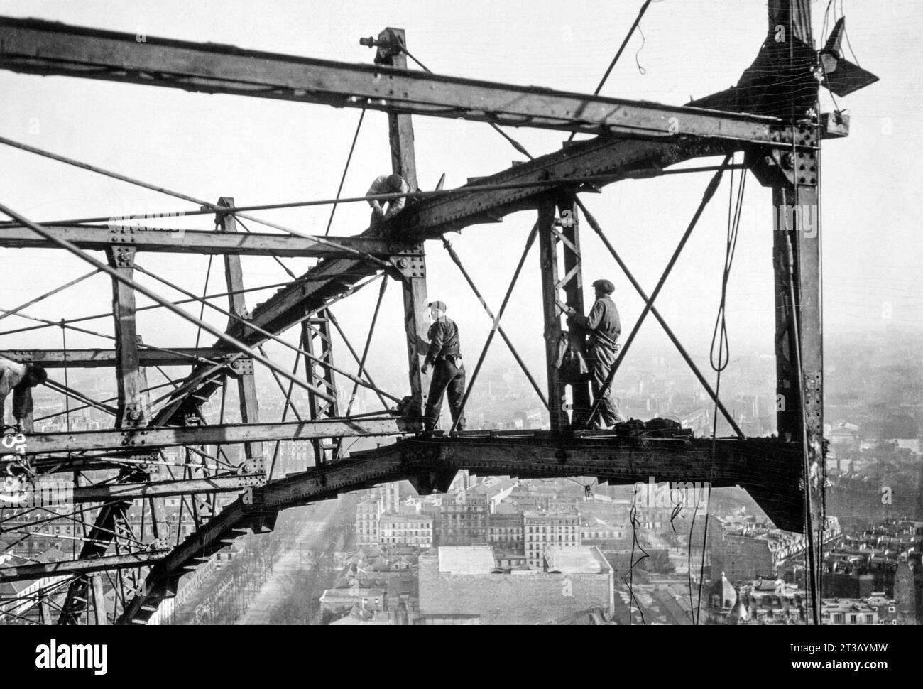 Photography , Workers dismantle piece by piece the Paris Ferris wheel built for the 1900 Universal Exhibition in Paris. Stock Photo