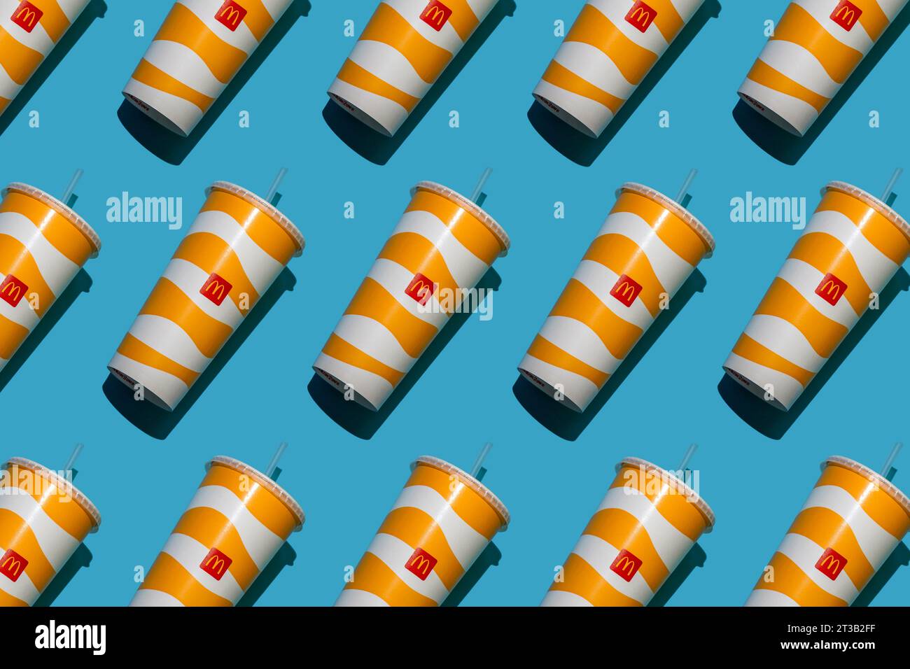 Yellow glass of McDonald's. Paper cup with lid. Takeaway drink ...