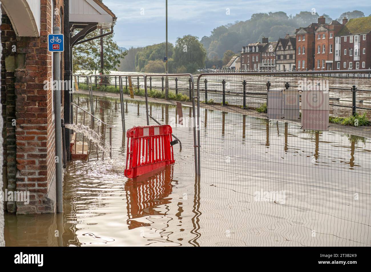 Bewdley, UK. 23rd October, 2023. Bewdley after Storm Babet. River levels remain very high and the flood barriers are still in place as large areas are engulfed by the swollen River Severn. River water floods and closes the road close to the corner to Beales corner where new flood defences sre being installed. Credit: Lee Hudson Stock Photo
