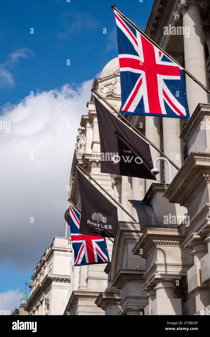 Union Jack flag flies on the exterior of the Old War Office OWO on Whitehall, London, now the upmarket Raffles Hotel. Stock Photo