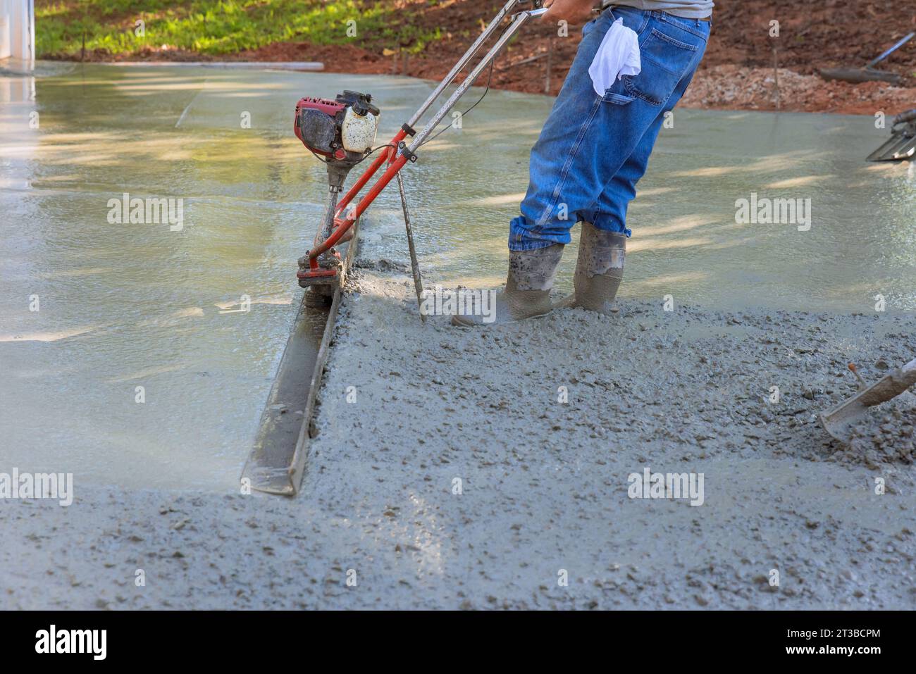 Fresh concrete driveway alignment using tamping machine for new