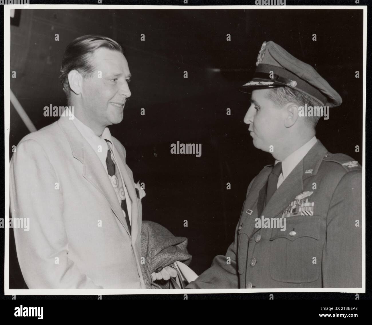 Neubiberg Air Base, Germany. Secretary of Labor, Maurice J. Tobin, is shown being greeted upon his arrival at Neubiberg Air Base, Germany, by Colonel George T. Lee, Deputy Commander, 86th Fighter-Bomber Wing, during the Secretary’s recent tour of US Zone of Germany, Colonel Lee is a resident of 26 Rock Street, Norwood, Massachusetts. Stock Photo