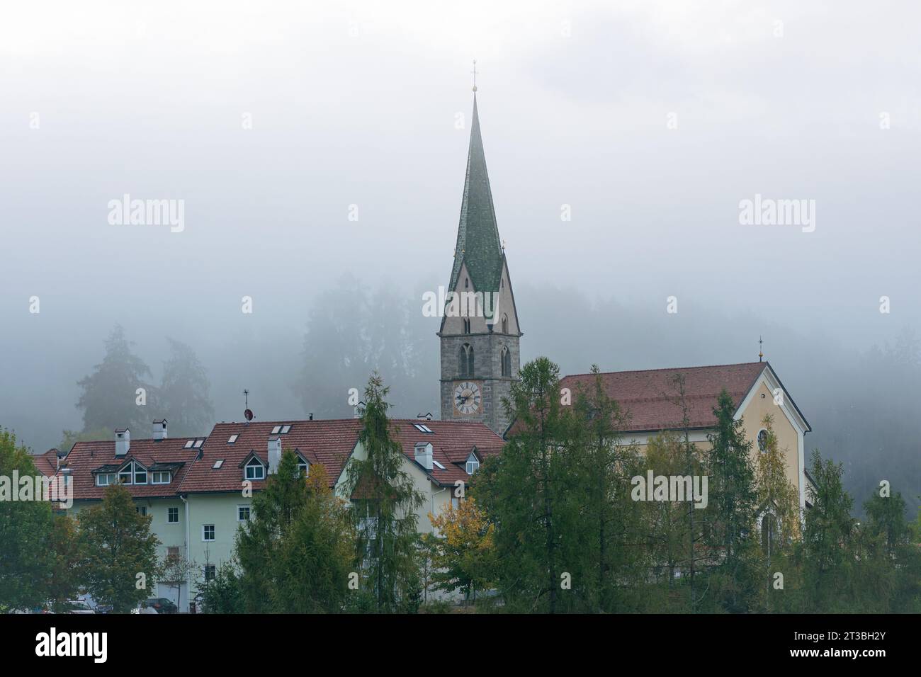 Church in the italian village of Terento (German: Terenten) in South Tyrol on a foggy morning. Stock Photo