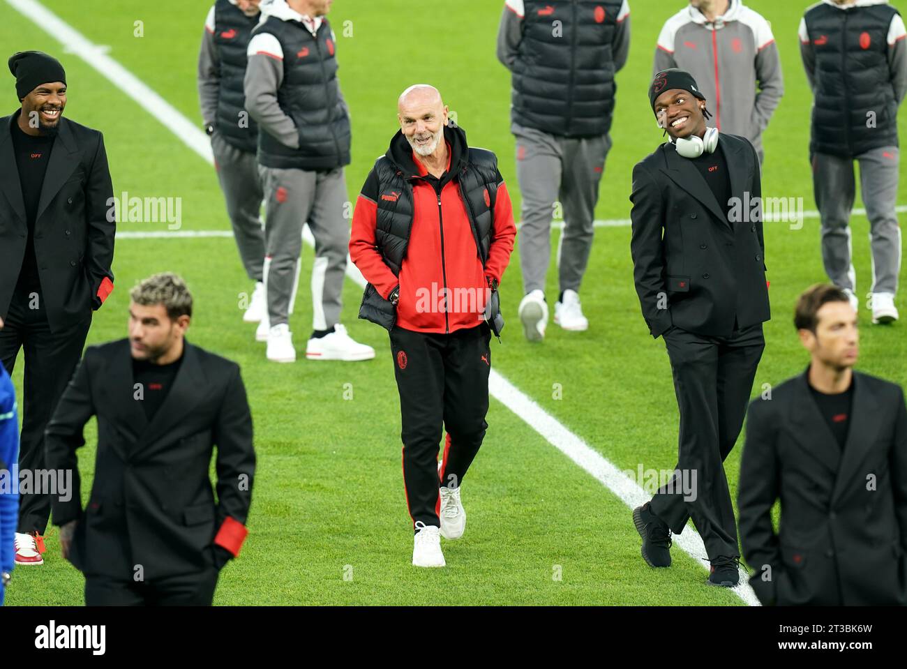 AC Milan manager Stefano Pioli (centre) inspects the pitch at Parc des