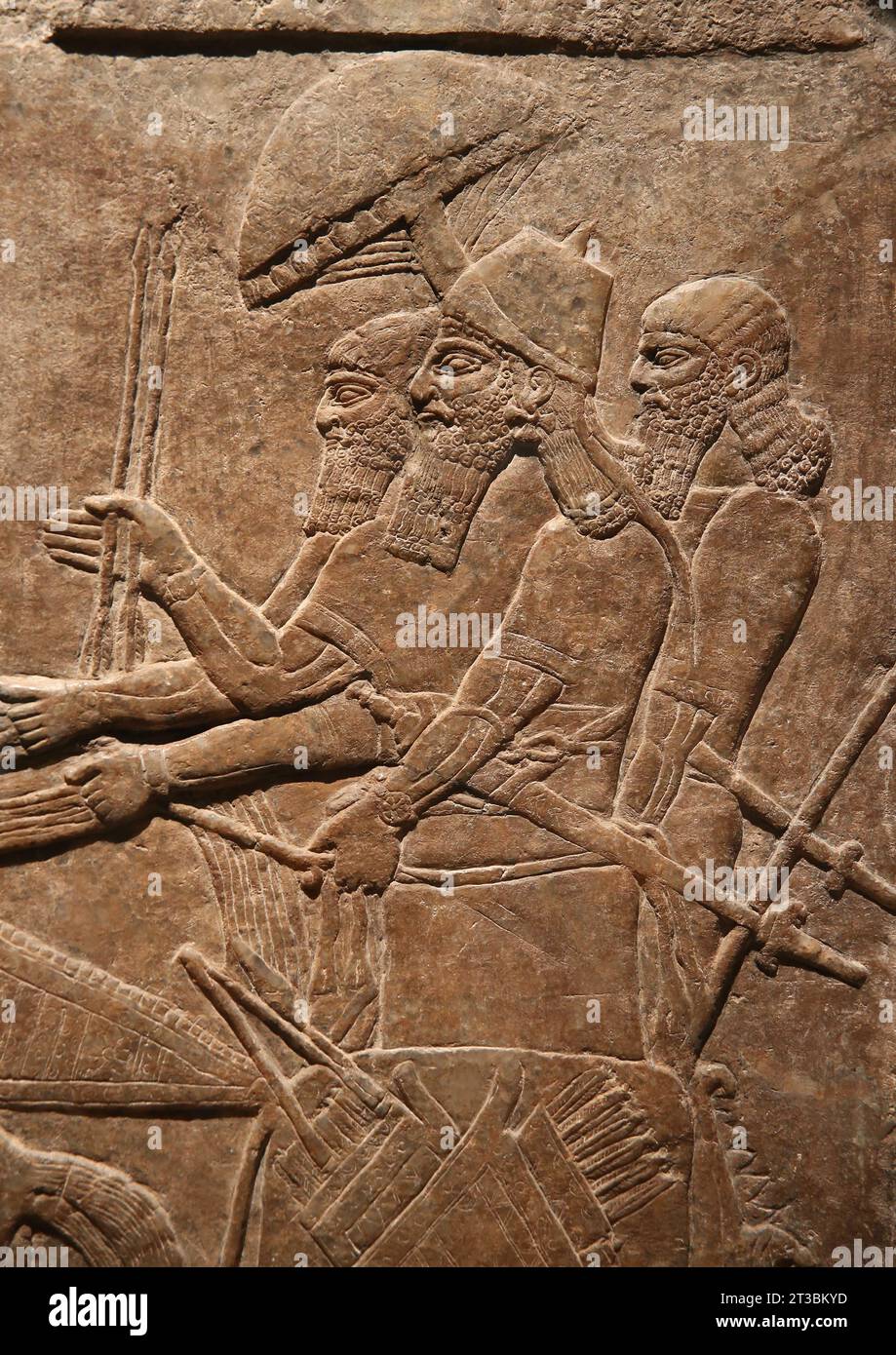 Nimrud palace wall relief (Iraq). Neo-Assyrian Empire. 875-860 BC. Alabaster. The monarch Ashurnasirpal II as a war hero in a chariot accompanied by s Stock Photo