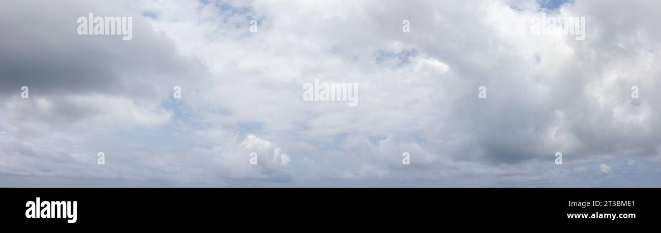 Panoramic grey sky with small blue sky patches Stock Photo