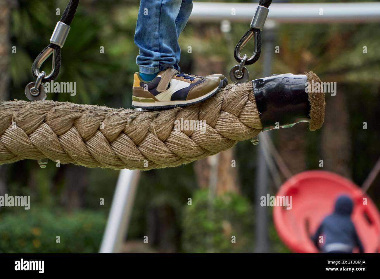 Swing The Rope Unrecognizablekid swinging from hanging rope at the park Stock Photo ...