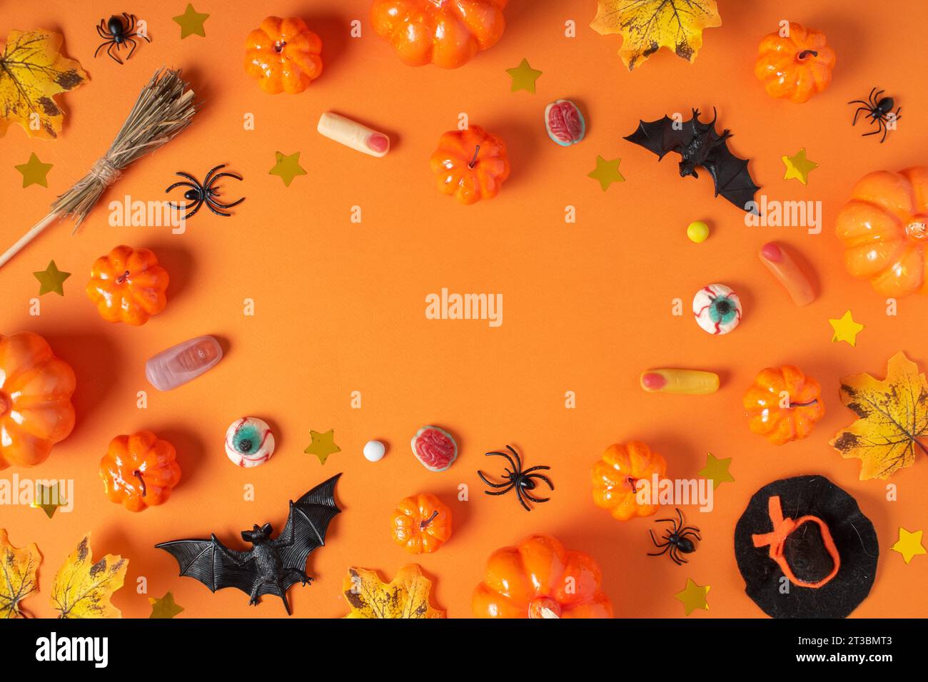 Halloween background with pumpkins and spiders on an orange background ...