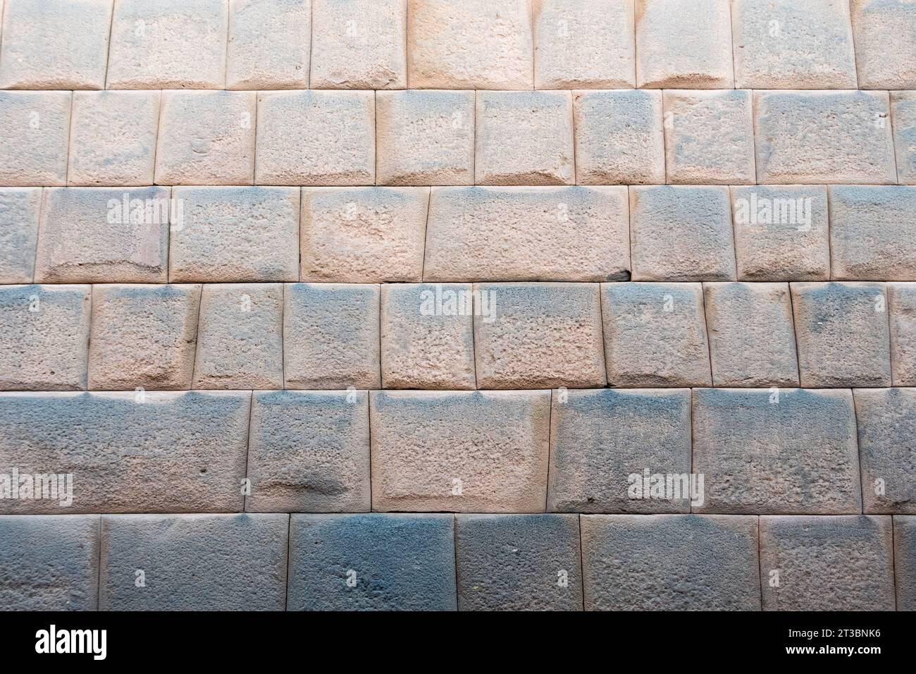 Inca stone wall in Cusco city. Spectacular wall formed by perfectly aligned and united blocks with nothing more than stone on stone Stock Photo