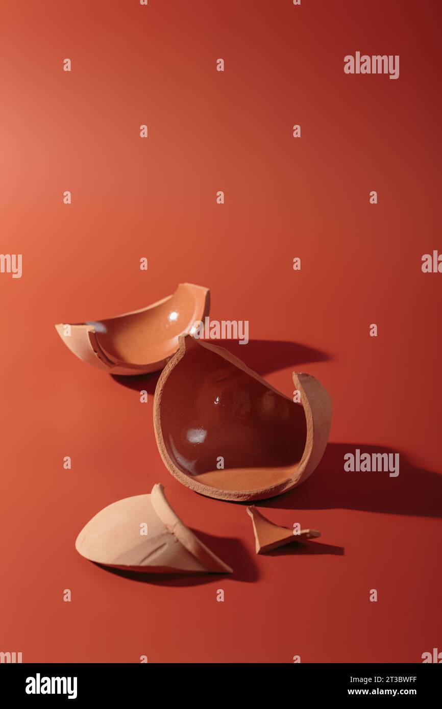 Details of broken ceramic cup on red background Stock Photo Alamy