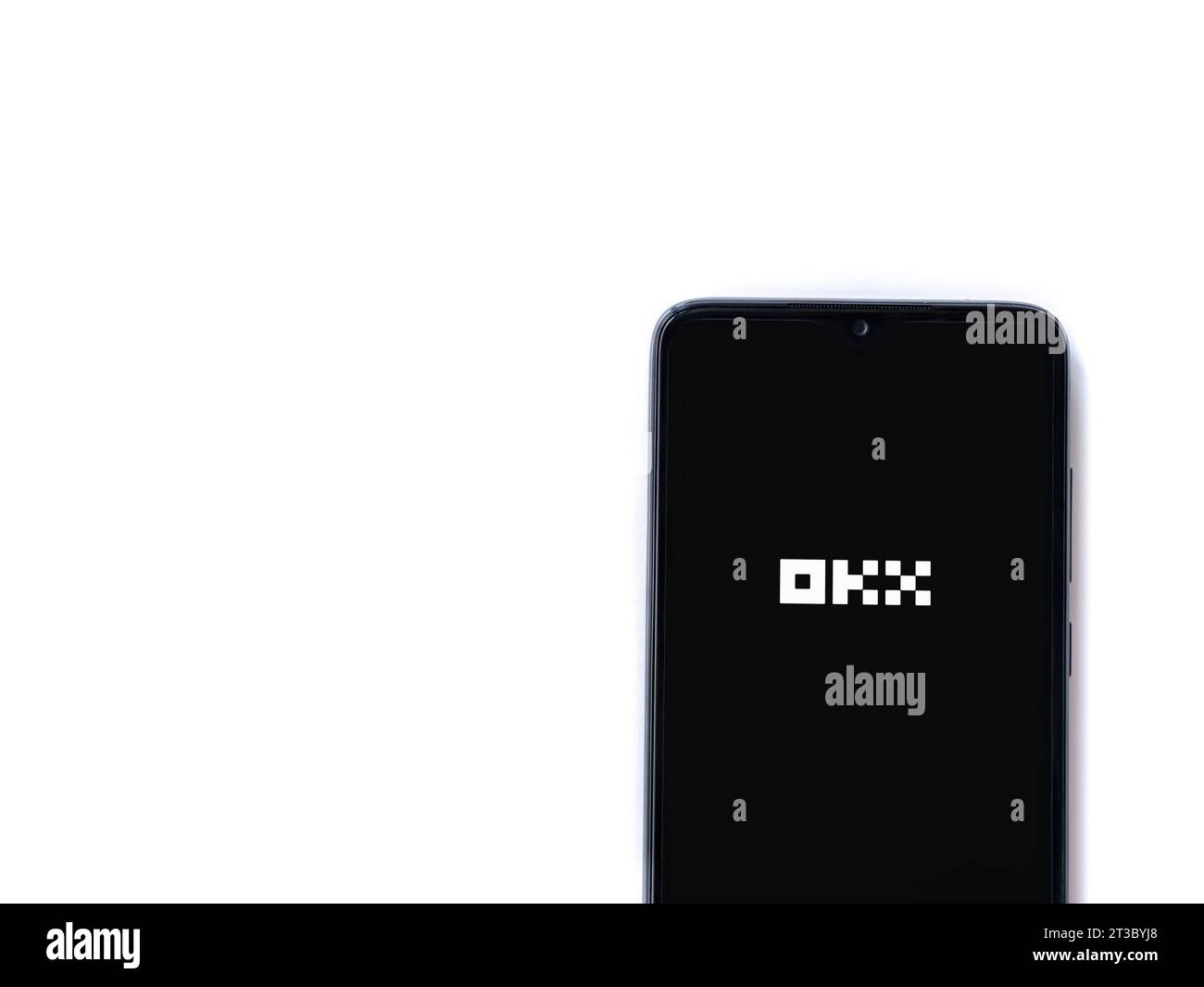 Lod, Israel - July 16,2023: OKX app launch screen on smartphone on white background. Top view flat lay with copy space. Stock Photo