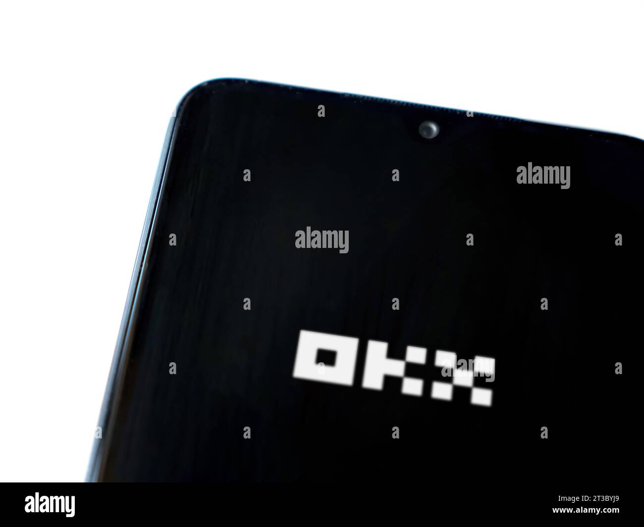 Lod, Israel - July 16,2023: OKX app launch screen on smartphone on white background. Top view flat lay with copy space. Stock Photo