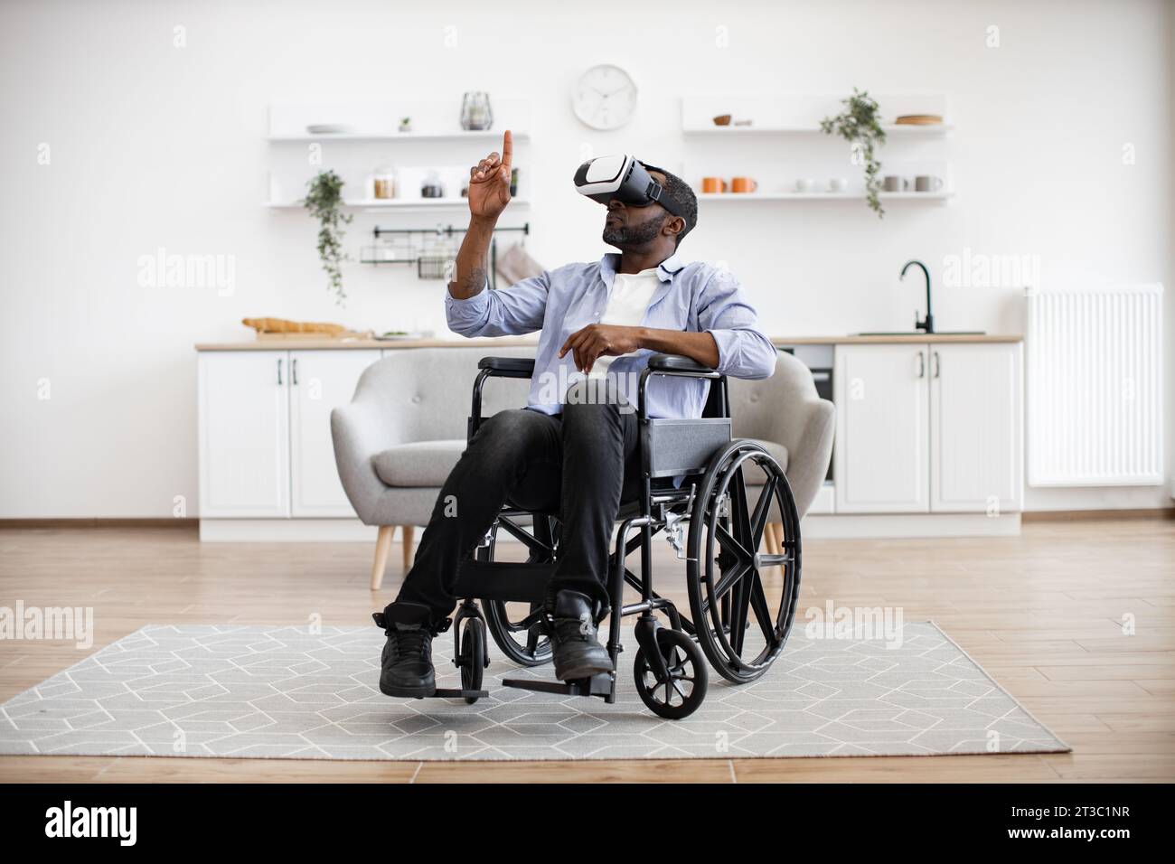 Disability Man Young african man with disability using modern technologies Stock Photo ...