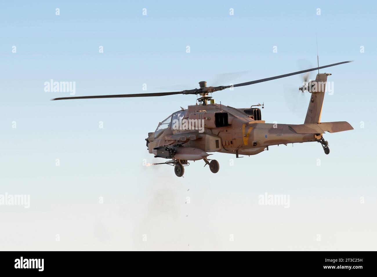 Israeli Air Force AH-64D Saraf helicopter practicing cannon fire over a ...