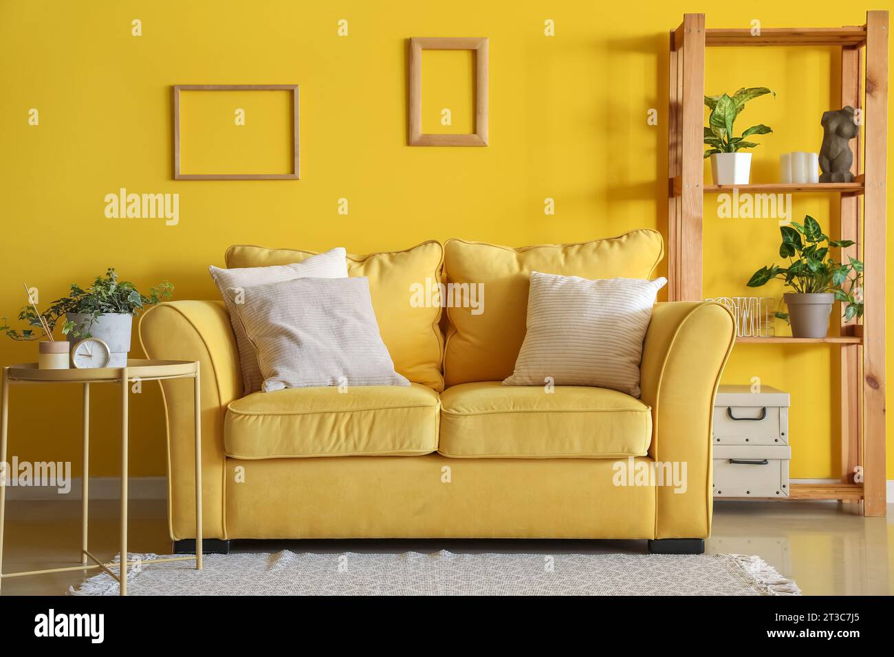 Interior of living room with yellow sofa and shelving unit Stock Photo ...